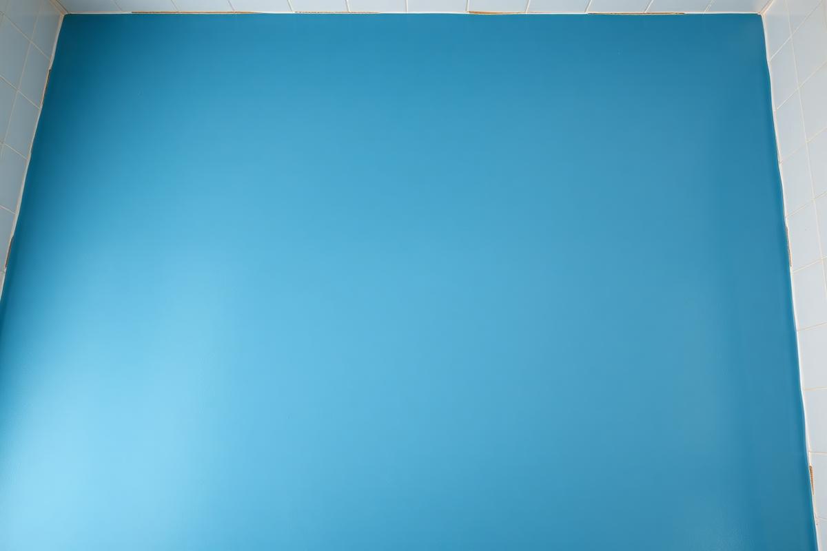 Blue waterproofing membrane applied to a bathroom floor